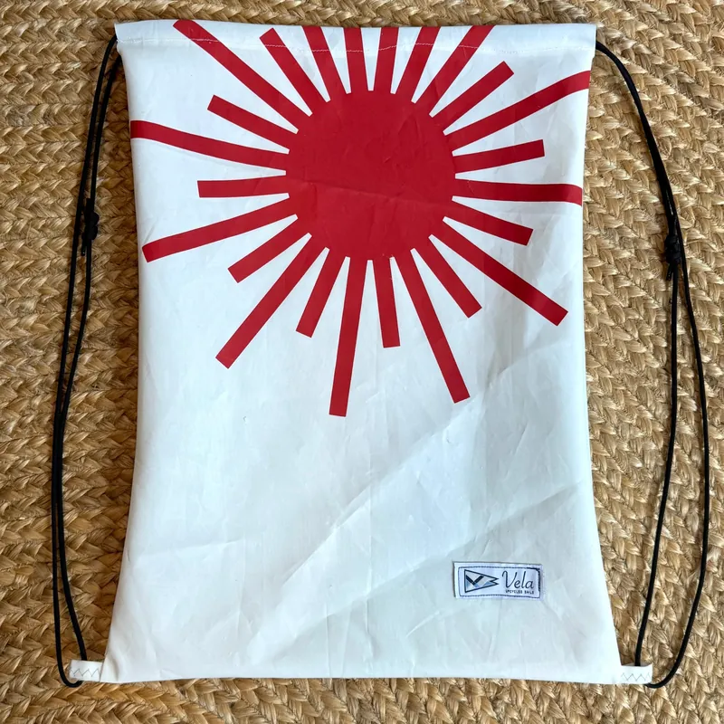 Vela drawstring bag, red sunburst on white sailcloth