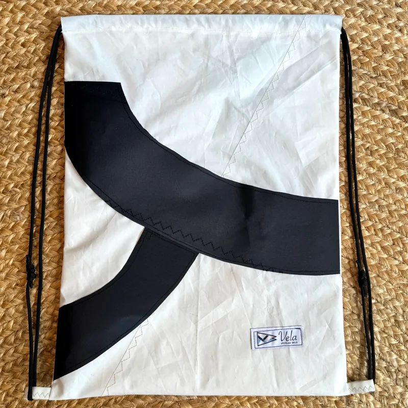 Vela drawstring bag, two crossing black arcs on white sailcloth